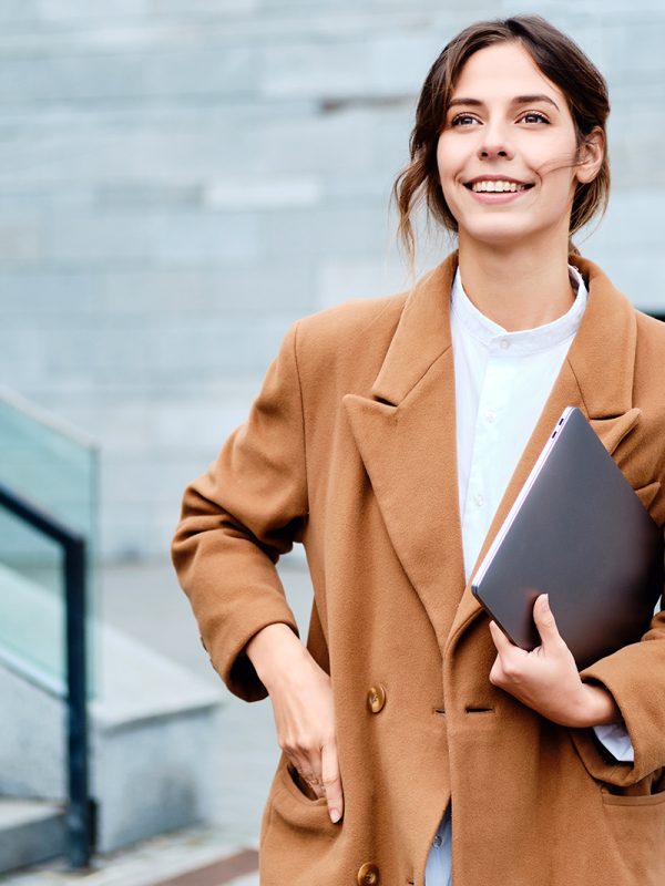 young-pretty-smiling-businesswoman-in-coat-with-2J3SG5G